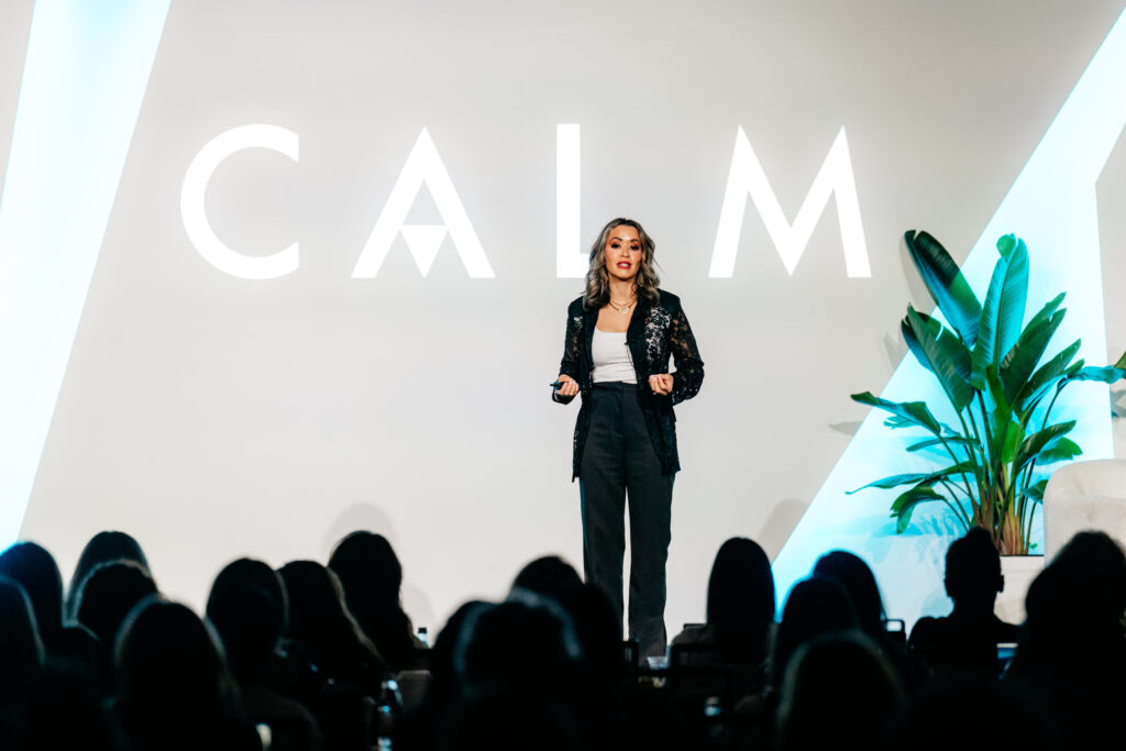 Lexi Yoo NP keynoting CALM in front of a packed audience