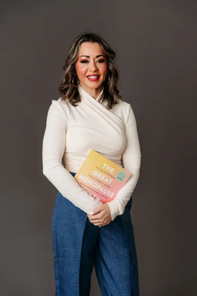 Lexi Yoo NP in a studio shot holding a menopause educational book