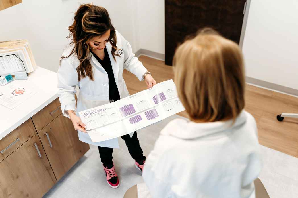 Lexi Yoo NP reviewing a hormone optimization chart with a patient in her clinic