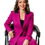 Lexi Yoo, nurse practitioner - Magenta pantsuit, seated in black chair, white background - confident general professional