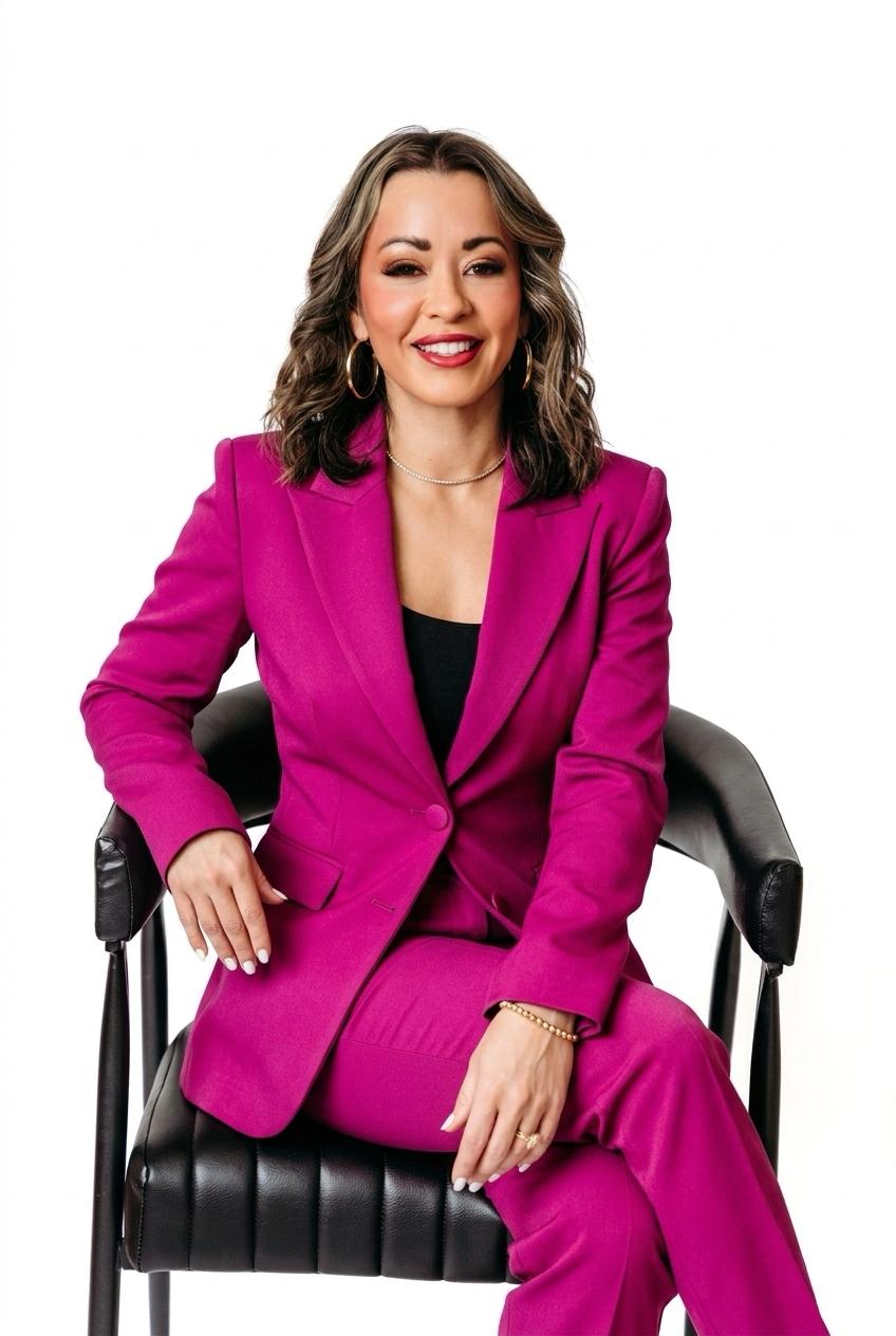 Lexi Yoo, nurse practitioner - Magenta pantsuit, seated in black chair, white background - confident general professional